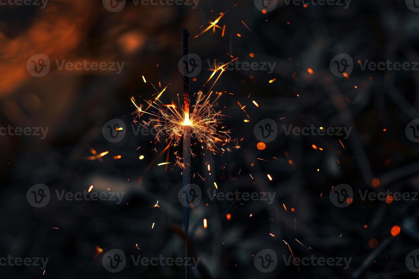 Burning sparkler spreading sparks and light on dark background photo