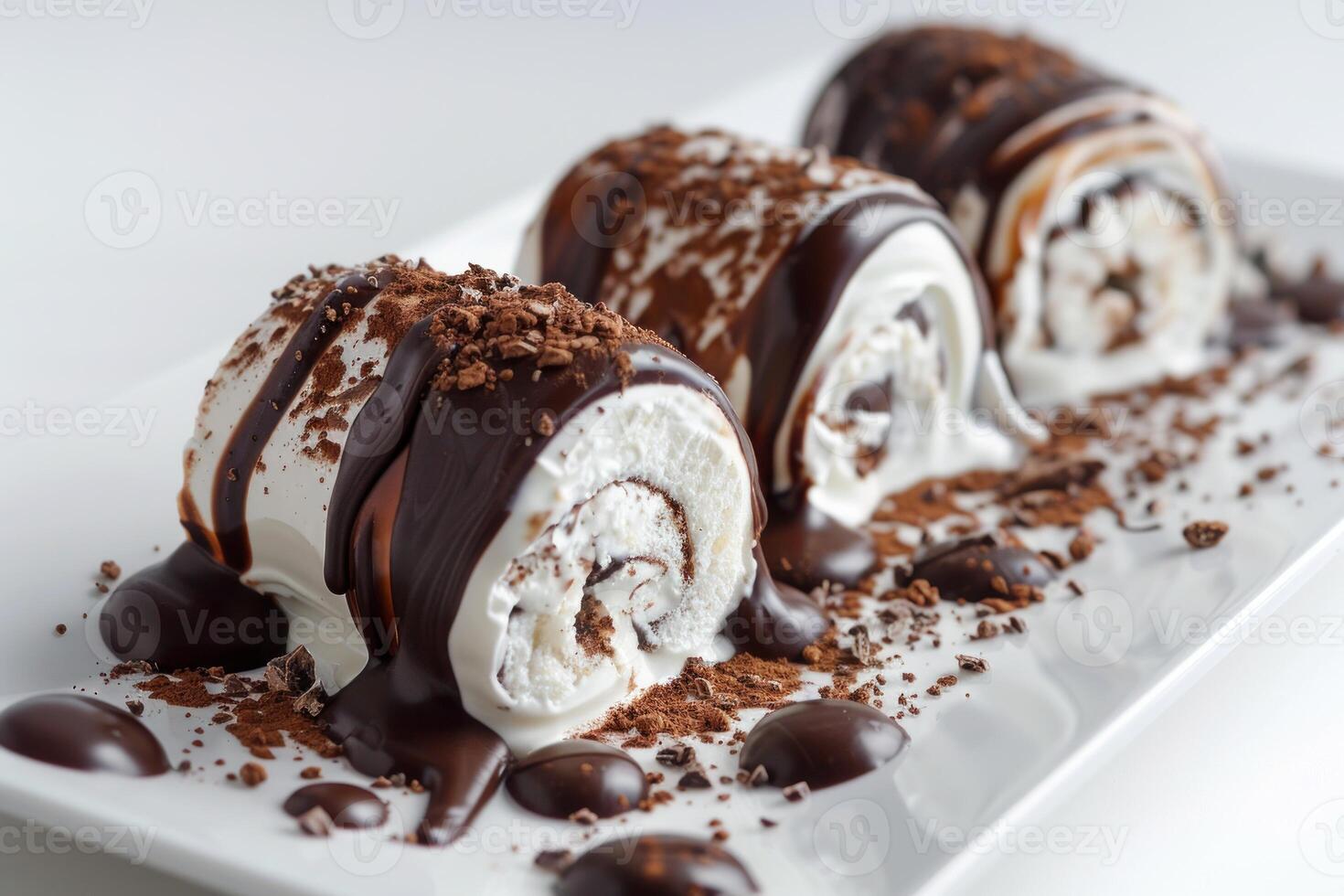 Delicious ice cream rolls covered in chocolate sauce being sprinkled with cocoa powder photo