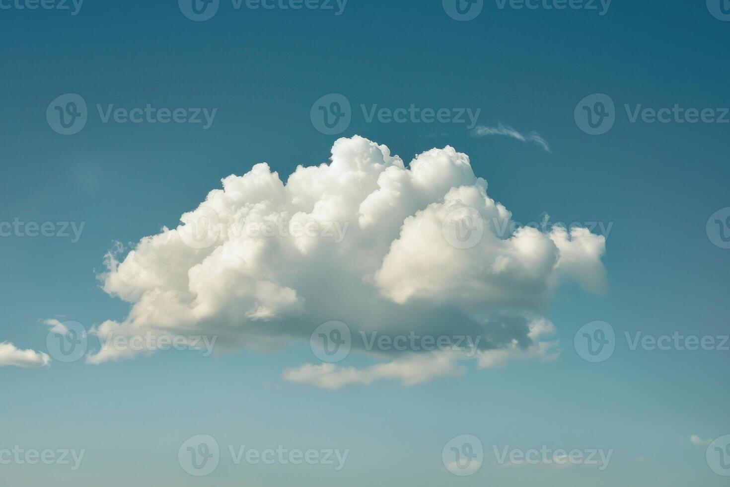 White cumulus cloud floating in a deep blue sky photo