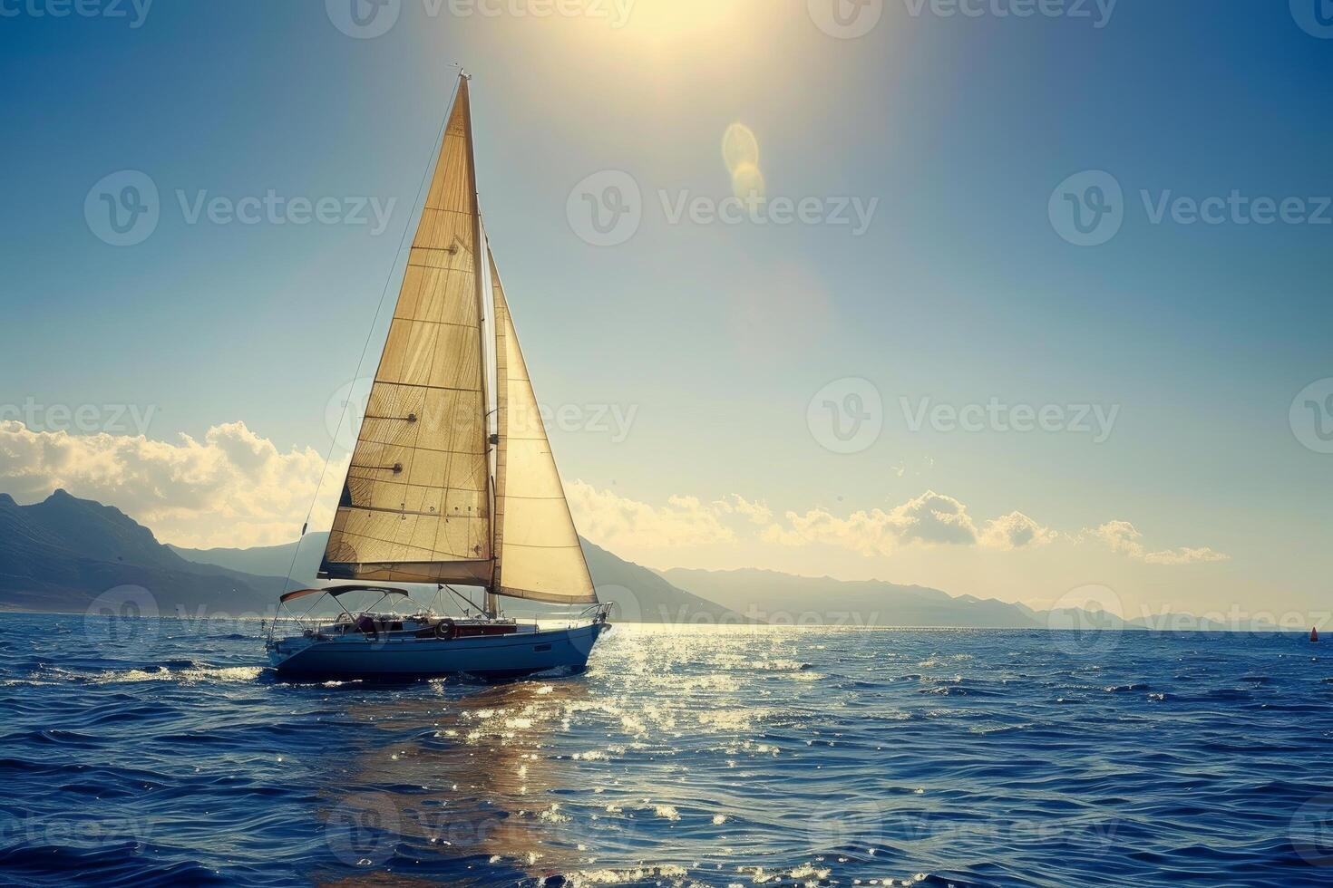 Yacht sails on a calm sea against a beautiful sunset backdrop photo