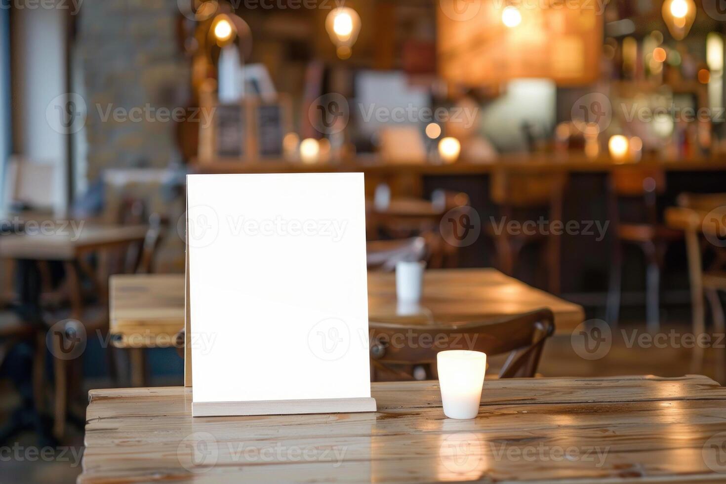 Blank menu sign standing on table in busy restaurant photo