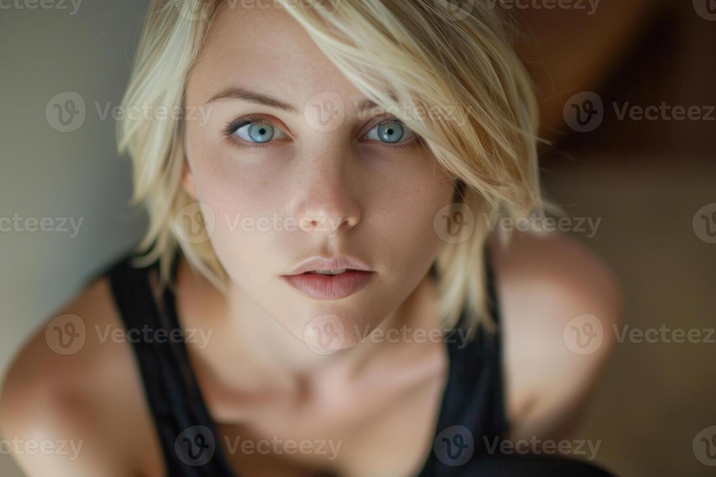 Young woman with blue eyes looking up at camera photo