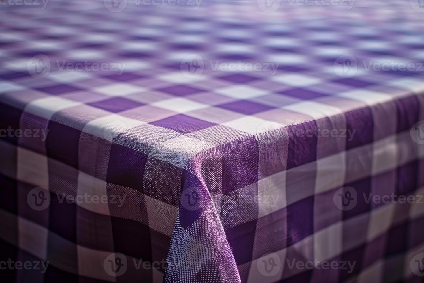Empty table covered with purple checkered tablecloth awaiting guests photo