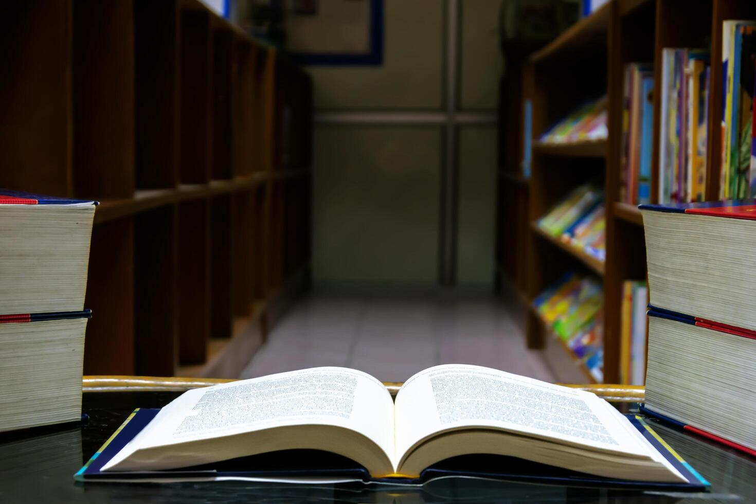 The open book was placed on a table in the library photo