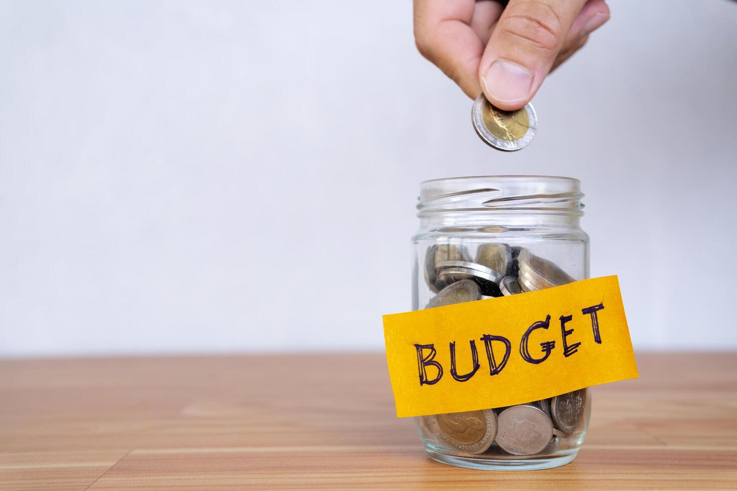 budget. Man holds coin in his hand photo