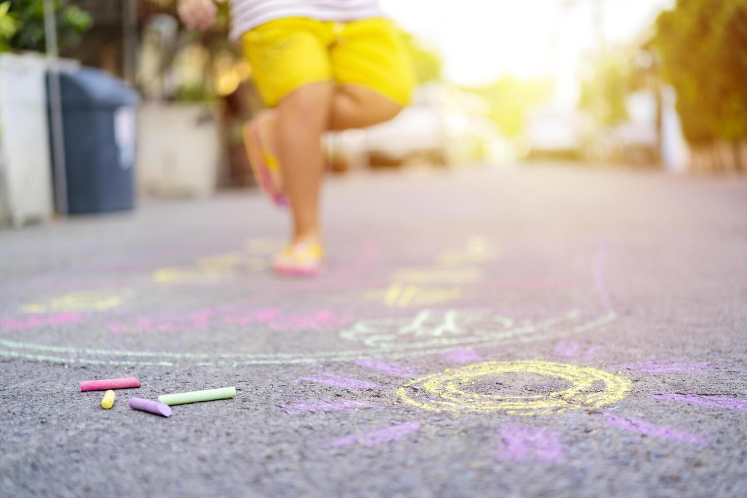 Asian children use chalk to write on the floor photo