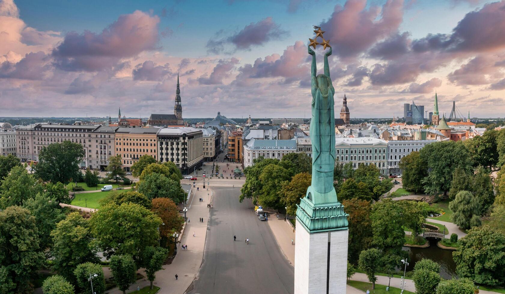 Beautiful sunrise view over Riga by the statue of liberty - Milda in Latvia. The monument of freedom. photo