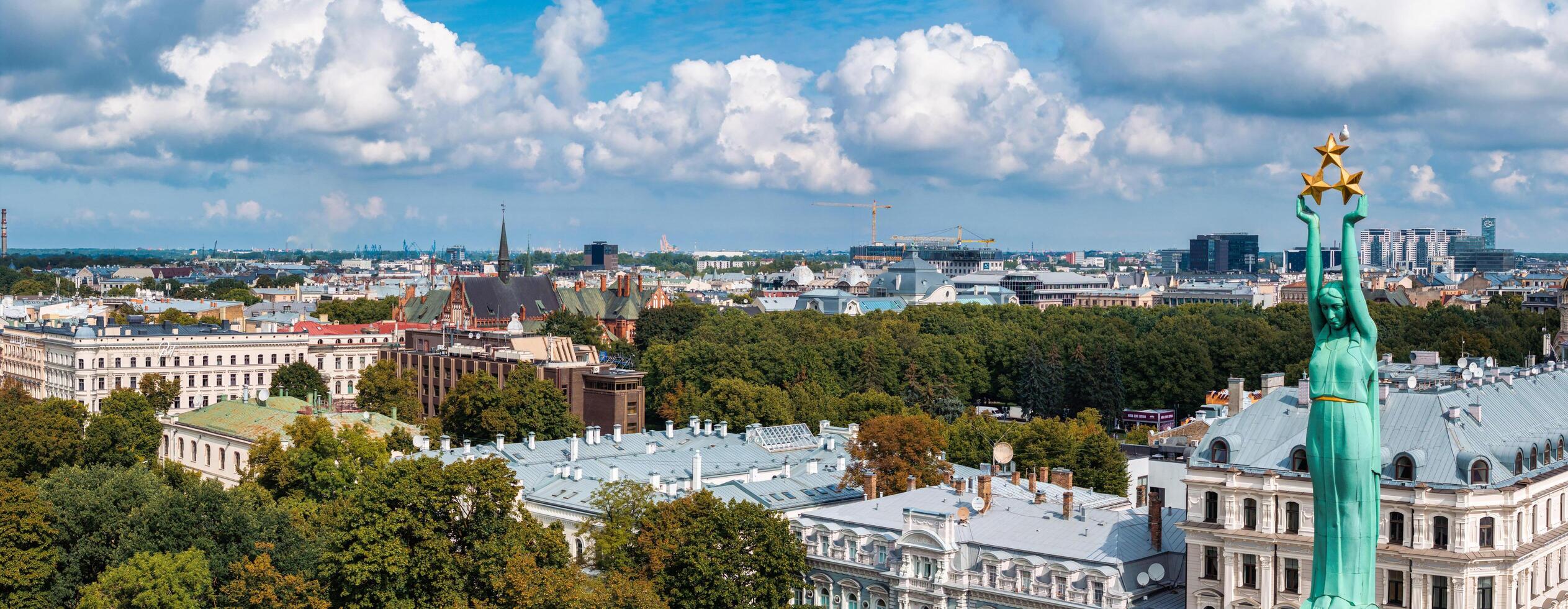 Beautiful sunrise view over Riga by the statue of liberty - Milda in Latvia. The monument of freedom. photo