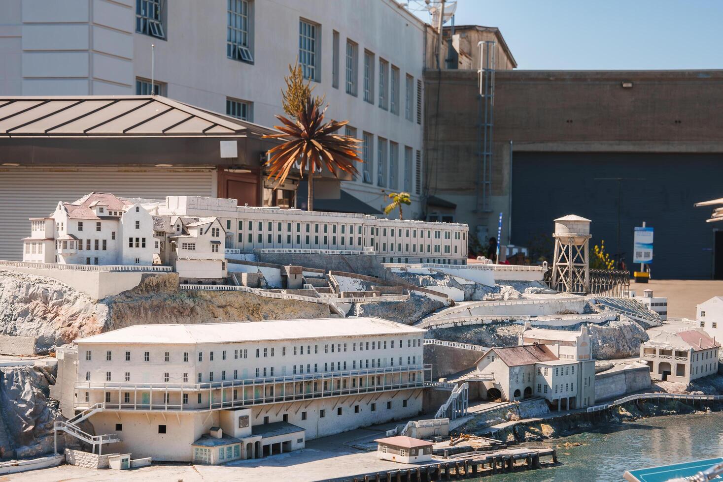 Detailed scale model of Alcatraz prison in San Francisco, USA. Model captures rugged terrain, prison complex, guard tower, and surrounding buildings with meticulous detail. photo