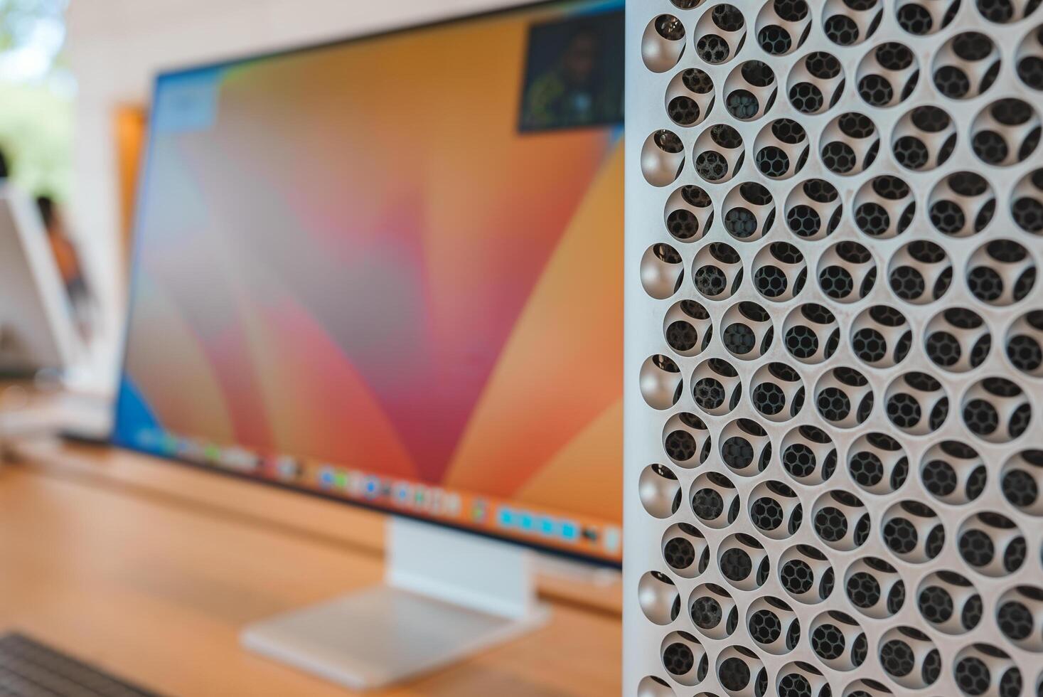 Close up view of Apple product display, featuring iMac with sleek screen and Mac Pro's distinctive circular holes. Location likely Apple Store in Mountain View. photo