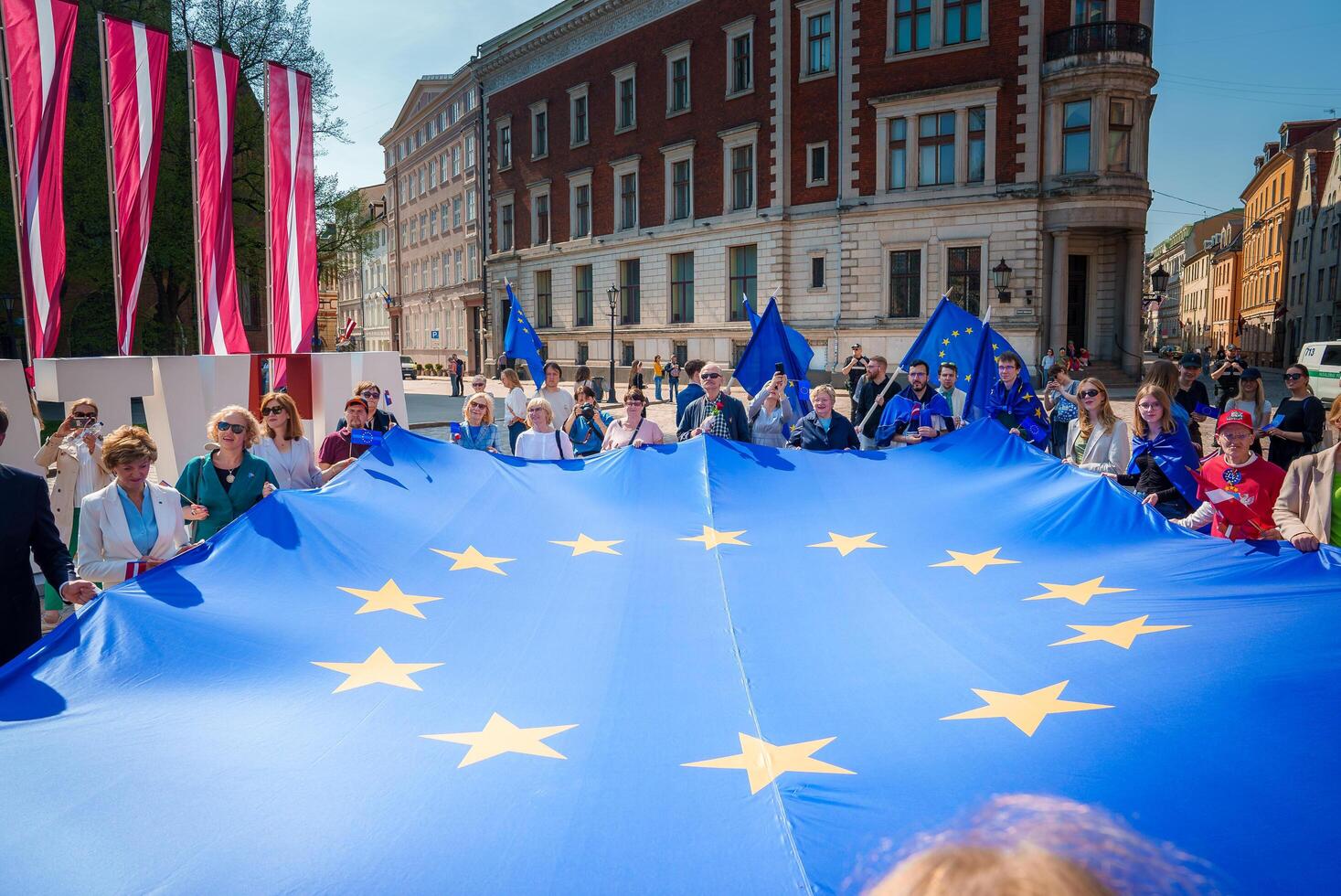 Vibrant Celebratory Scene in Old Town Riga, Latvia photo