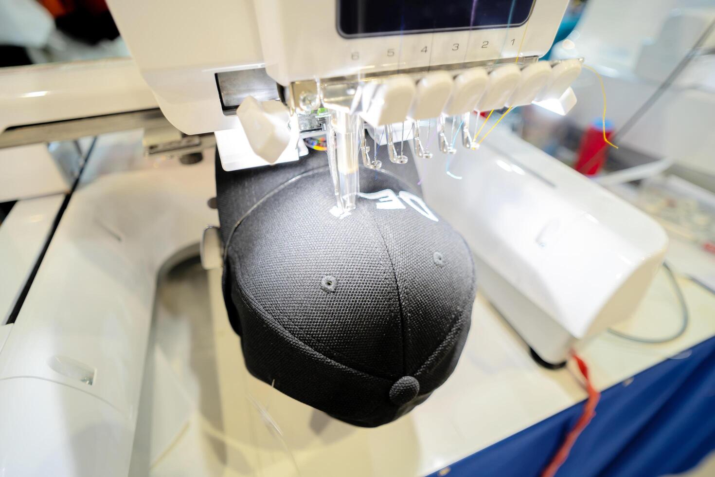 Close up picture workspace of embroidery machine stitching a logo photo
