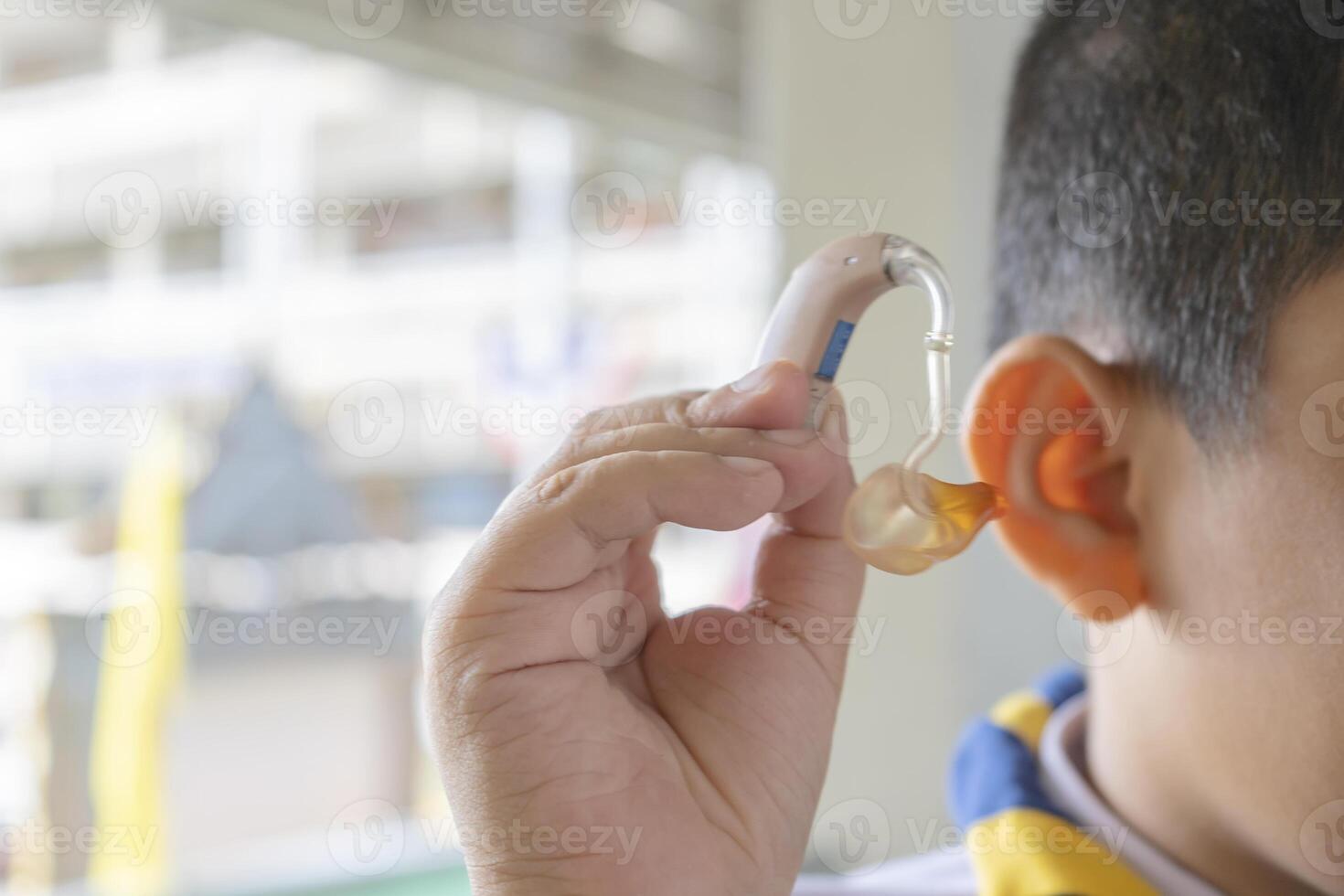 An Asian student, she has to use a hearing aid. photo