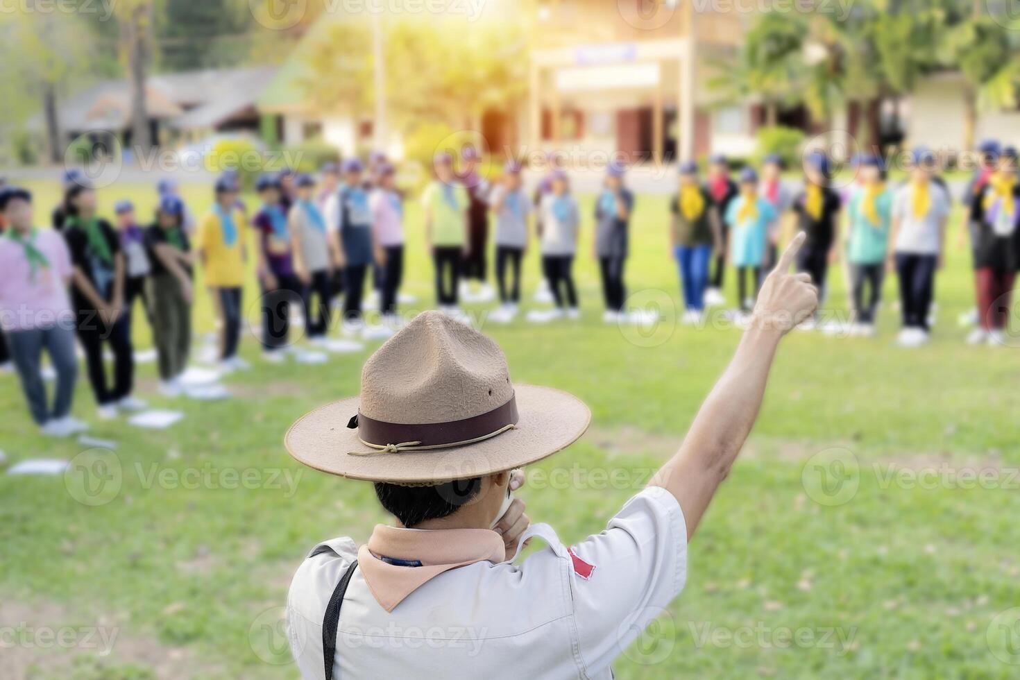 The Scout director is teaching activities in the middle of the lawn. photo