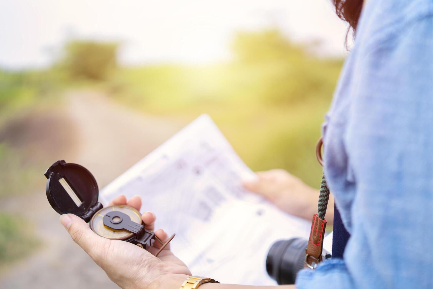 Female tourists are using a compass and map photo
