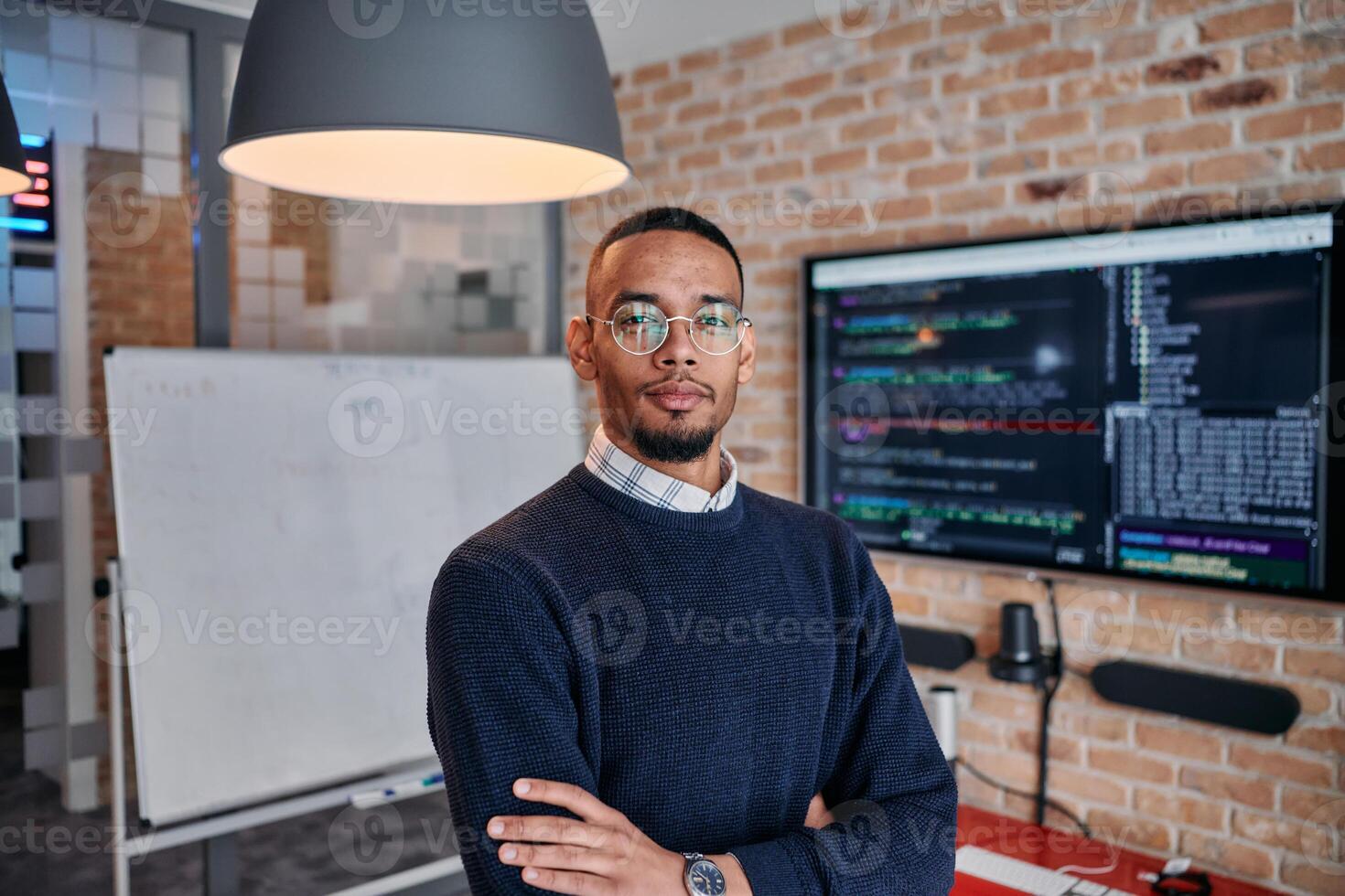 Startup Leadership. African American Businessman in Modern Office with Colleagues in Background. photo