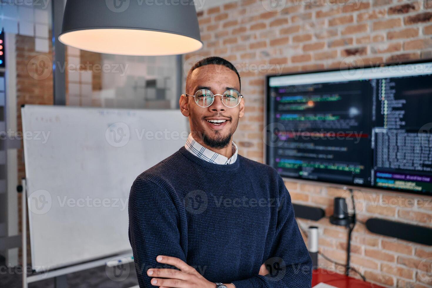 Startup Leadership. African American Businessman in Modern Office with Colleagues in Background. photo