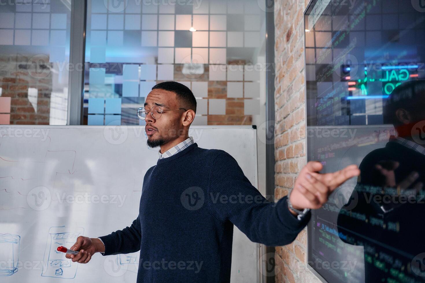 African American businessman delivers a compelling presentation of his business strategy to his colleagues, fostering collaboration and forward thinking photo