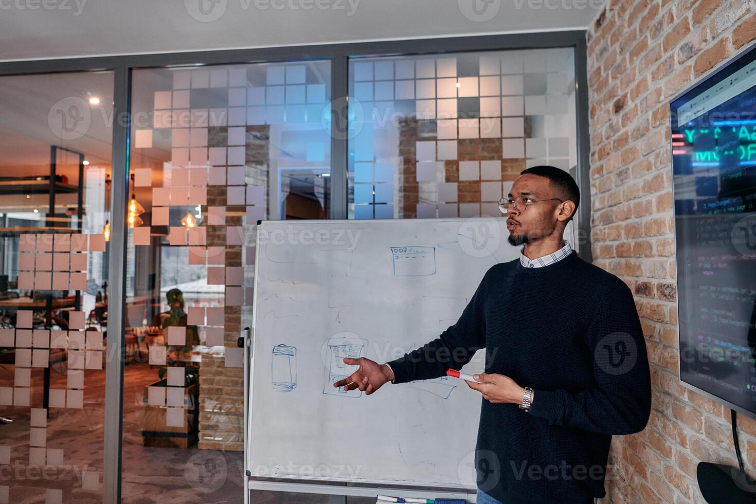 African American businessman delivers a compelling presentation of his business strategy to his colleagues, fostering collaboration and forward thinking photo