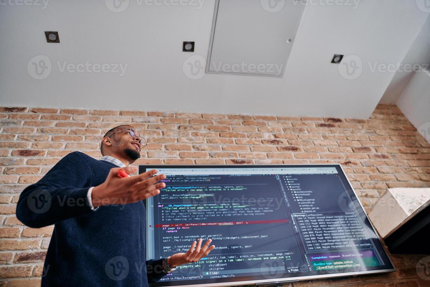 African American businessman delivers a compelling presentation of his business strategy to his colleagues, fostering collaboration and forward thinking photo