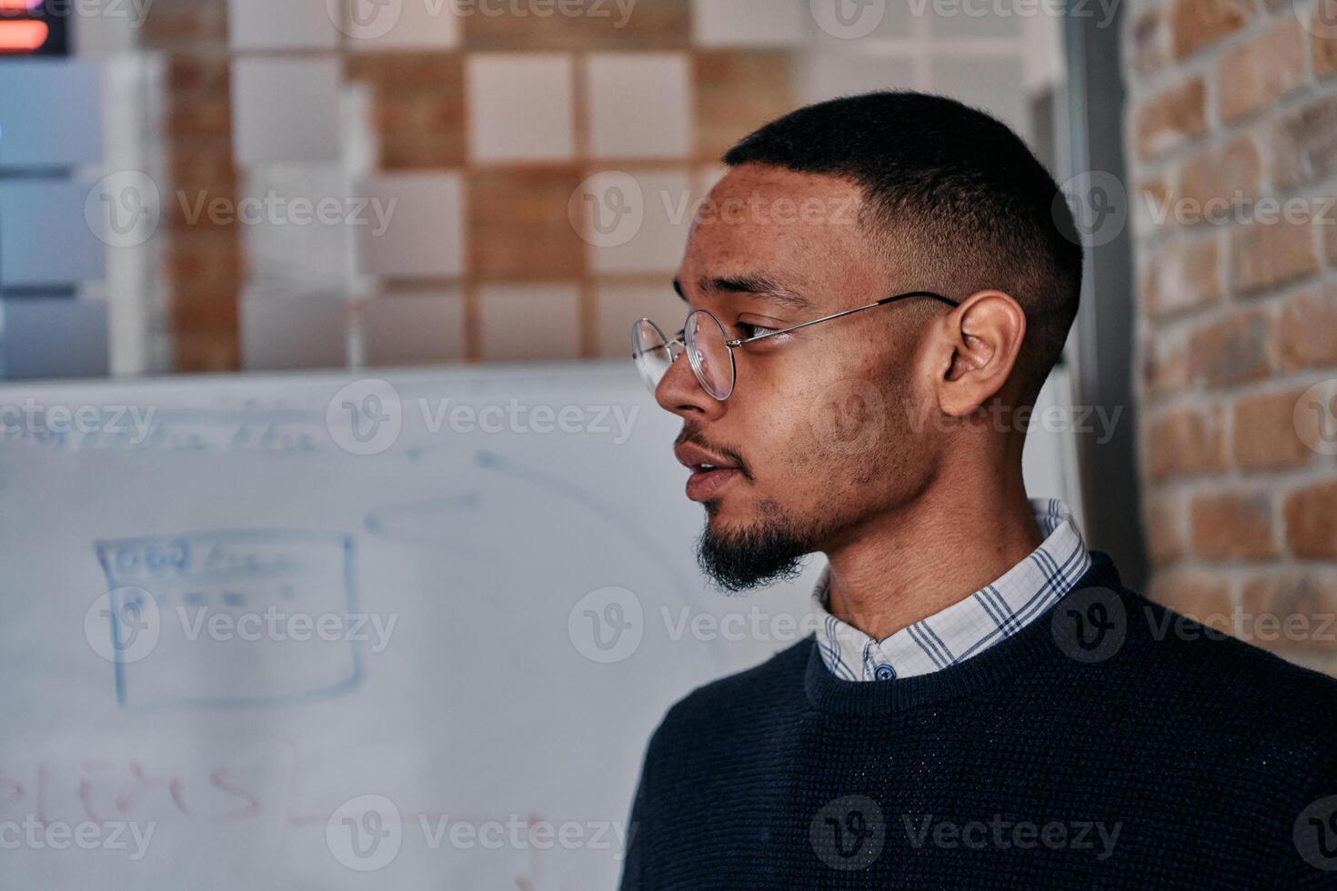 African American businessman delivers a compelling presentation of his business strategy to his colleagues, fostering collaboration and forward thinking photo
