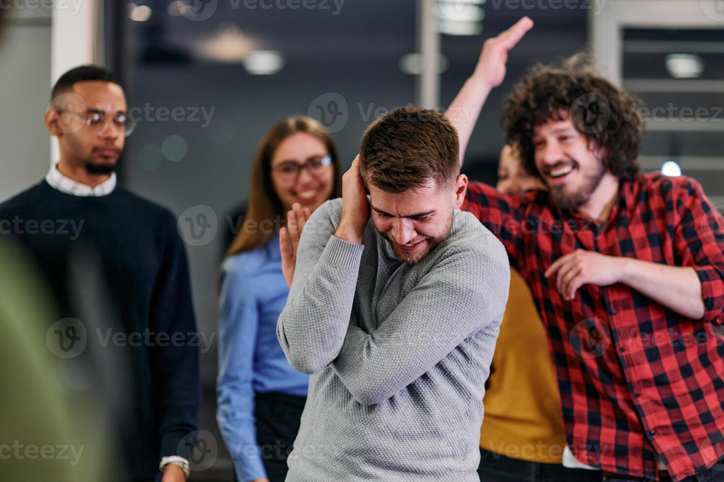 A group of young business people have fun playing interesting games while taking a break from work in a modern office. Selective focus photo