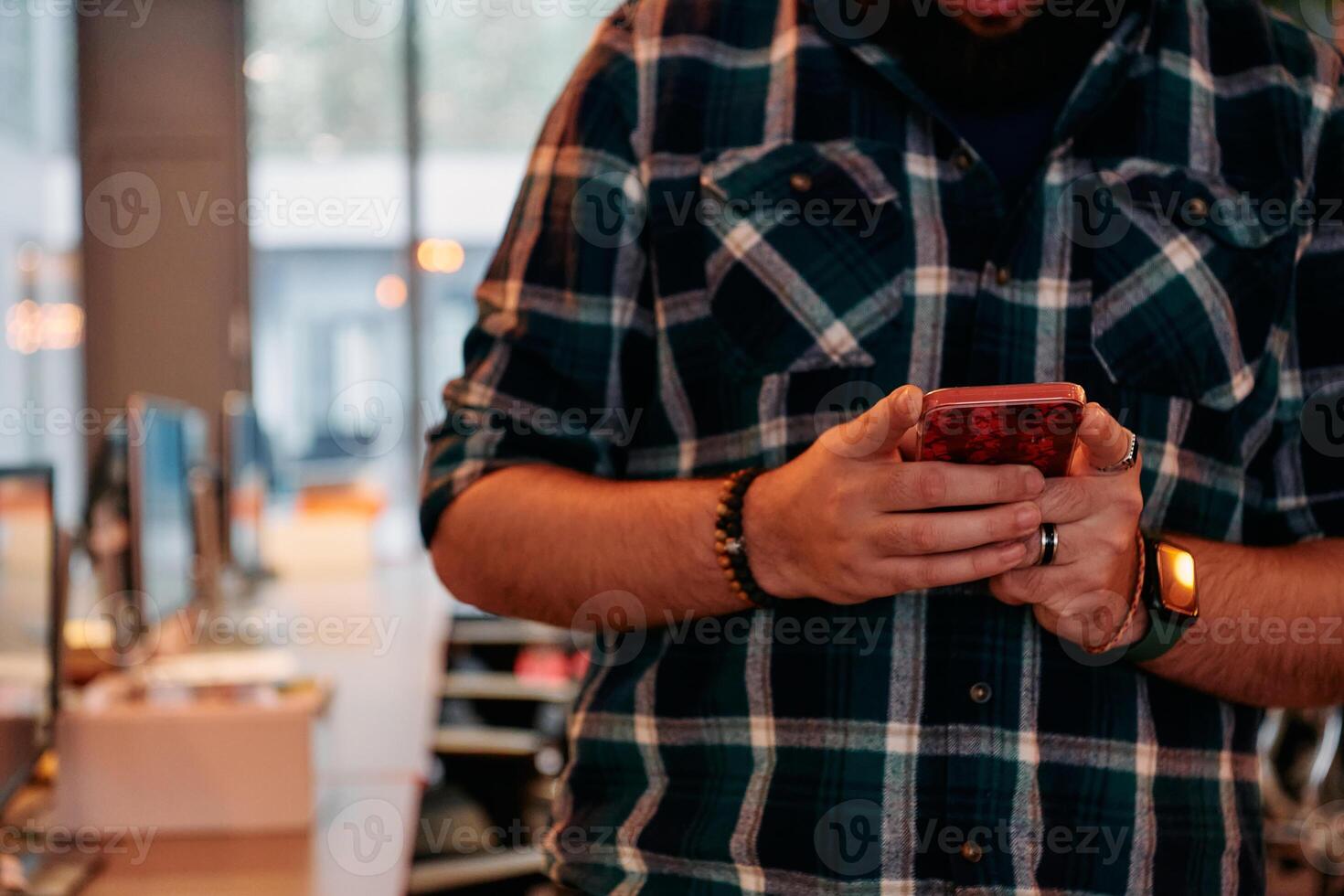 Close Up Young Bearded Programmer Using Smartphone in Office photo