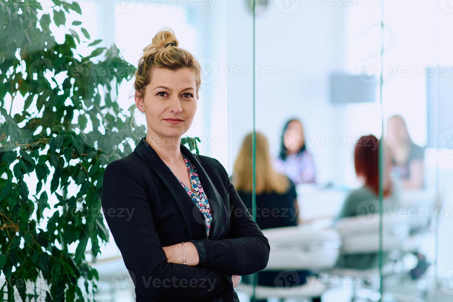 Brunette Businesswoman with Crossed Arms Standing in Front of Modern Office. photo