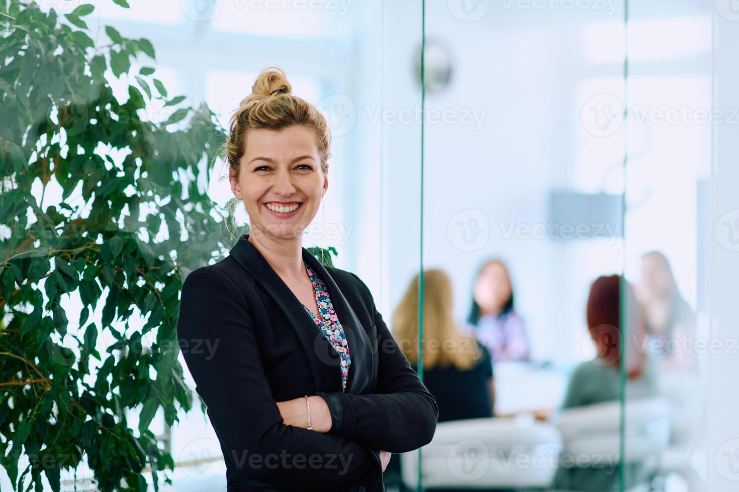 Brunette Businesswoman with Crossed Arms Standing in Front of Modern Office. photo