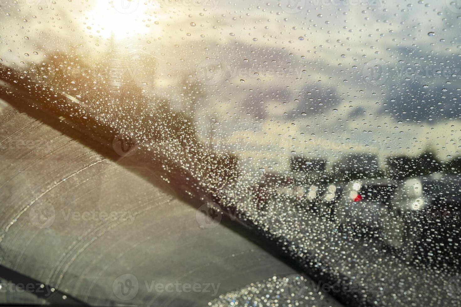 Raindrops closely from the windshield, dark clouds, evening heavy rain photo