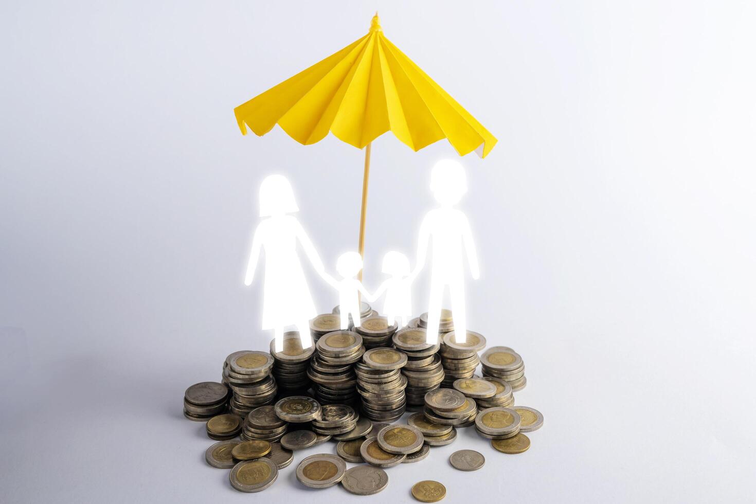 Coin stacks with family with the protect umbrella on dark background , business idea and insurance concept photo