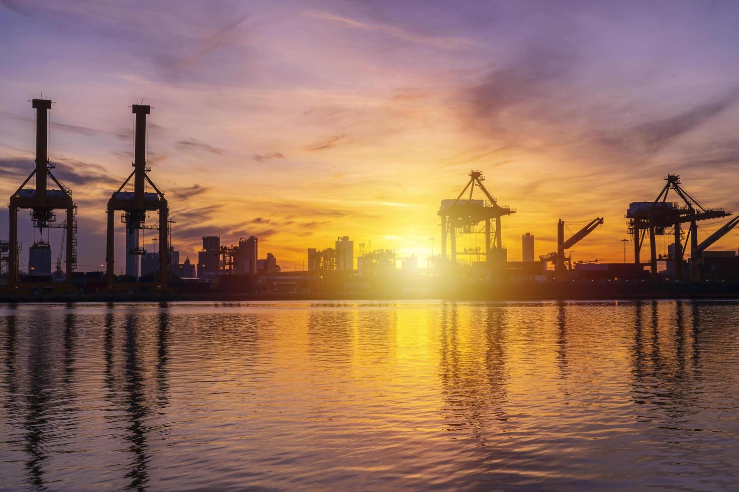 Cargo port that works continuously for loading and unloading goods, water reflection view photo