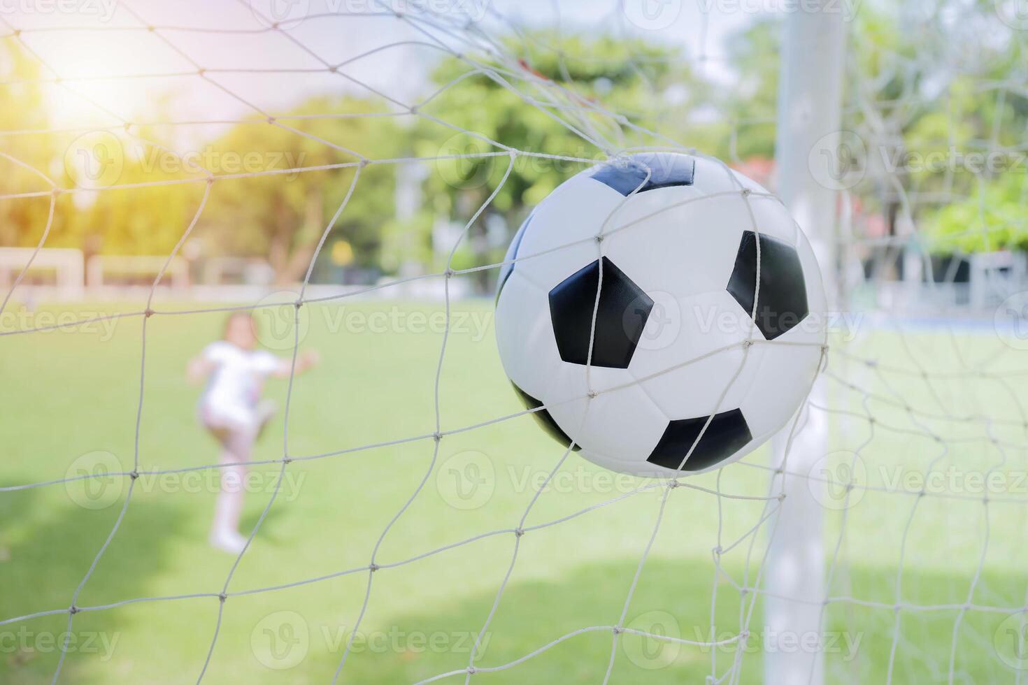 Children who kick the ball into the goal until the net. photo