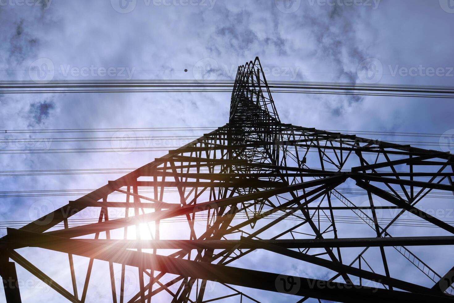 bottom view of high voltage pole power transmission tower. photo