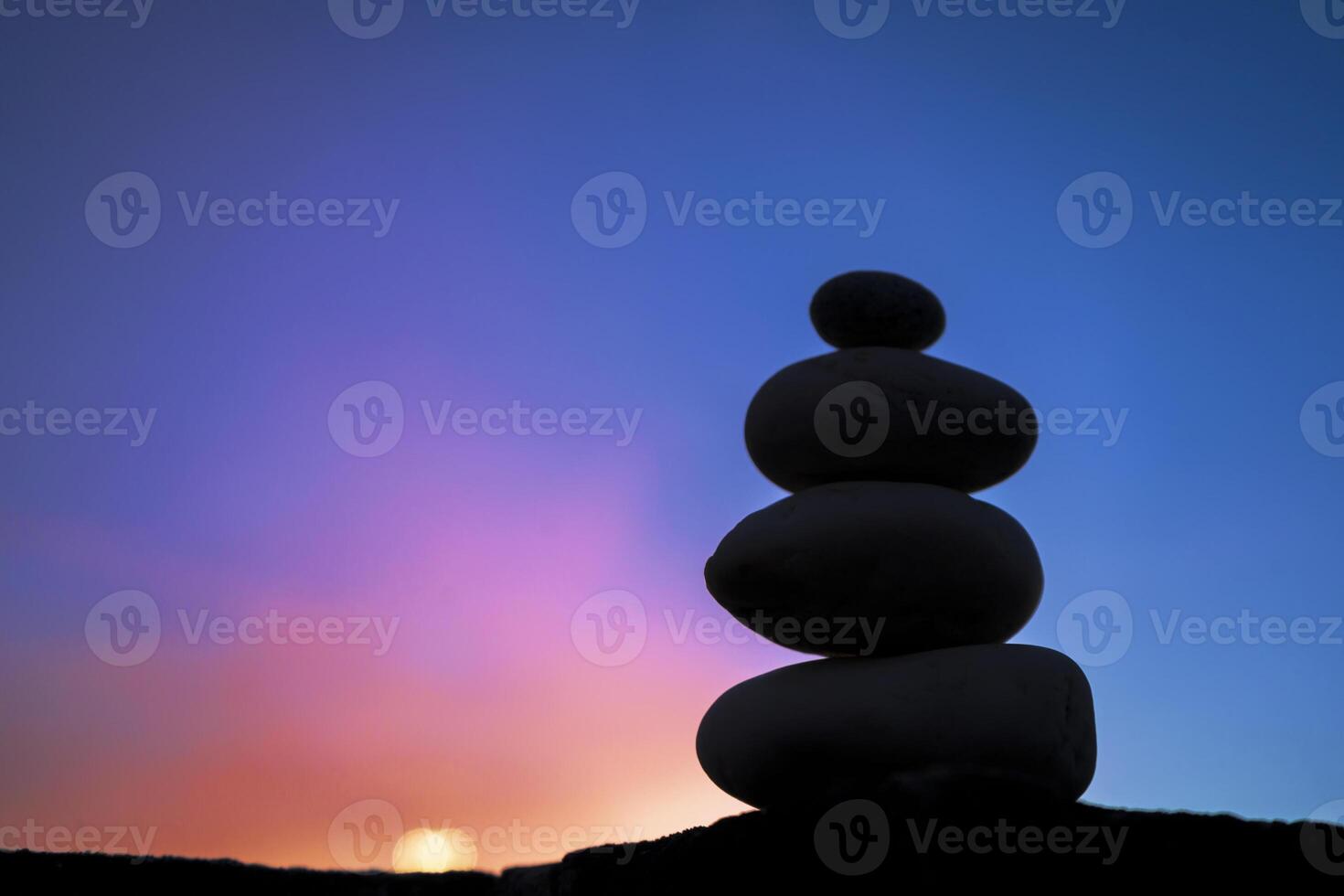 The stones that are stacked together are comparable to yoga meditation. photo