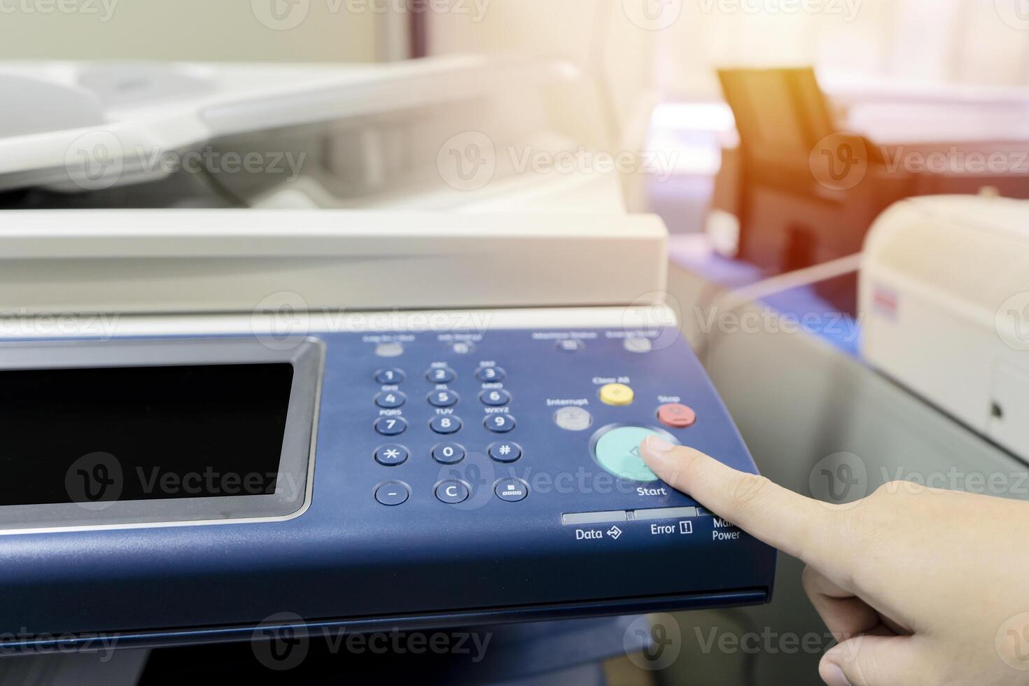 Fingers that are pressing the button the printer. photo