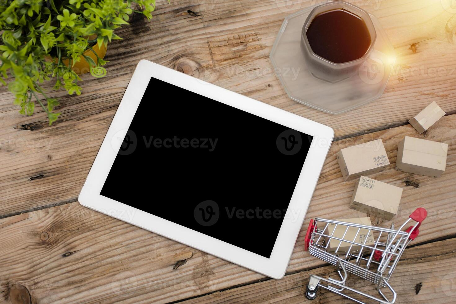 Paper boxes in shopping carts on desks and tablets. photo