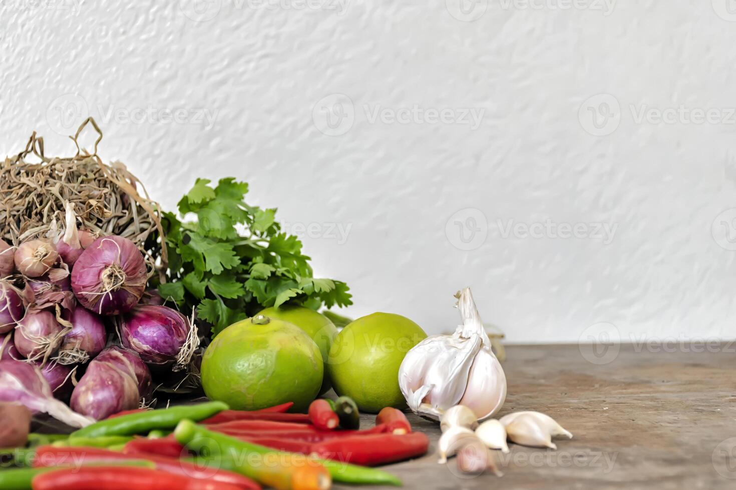 Seasoning concept. Composition of various herbs and spices isolated put on a wooden table. photo