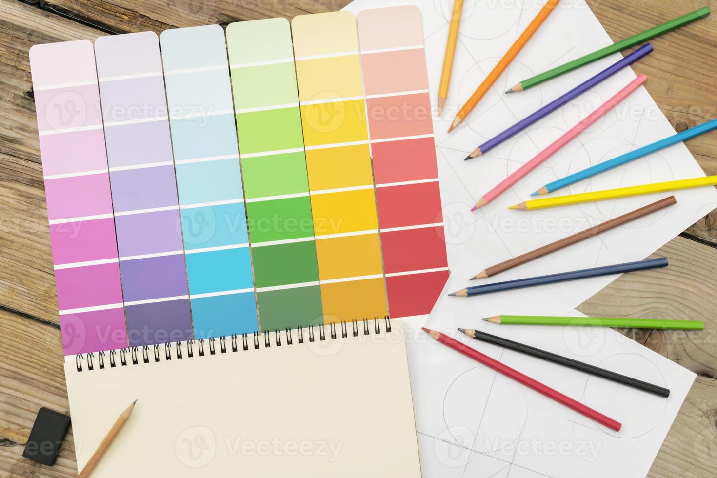 Various shades used in the design, creation, work. Are placed on a desk with colored pencils. photo