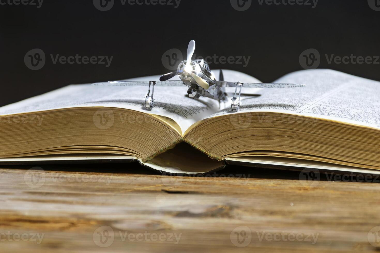 Plane is placed on the book. photo