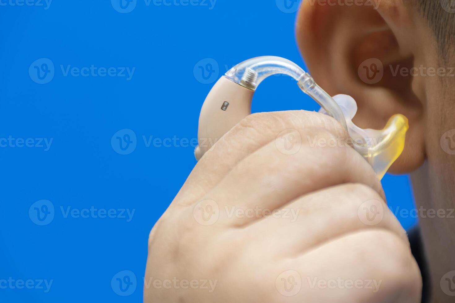 Hand that is catching hearing aid. photo