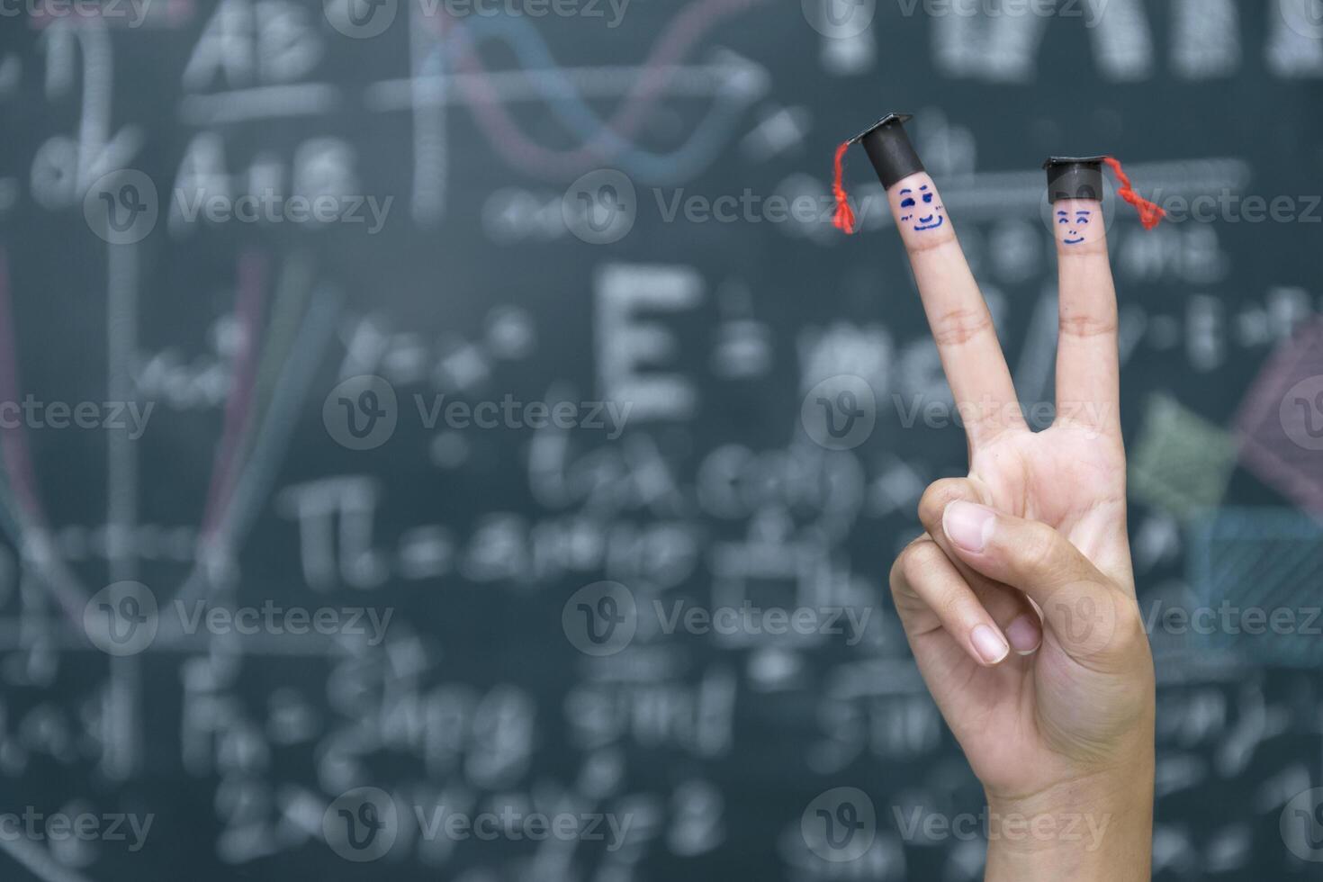 Graduation cap wear on Index finger and middle finger photo