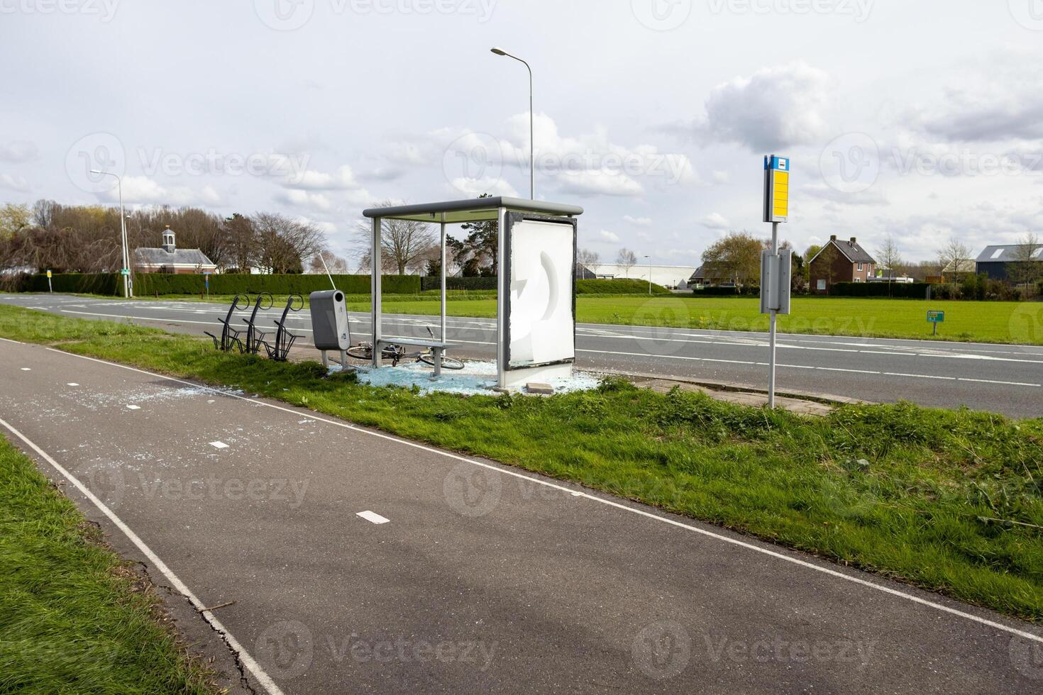 demolished bus stop in besides a road photo