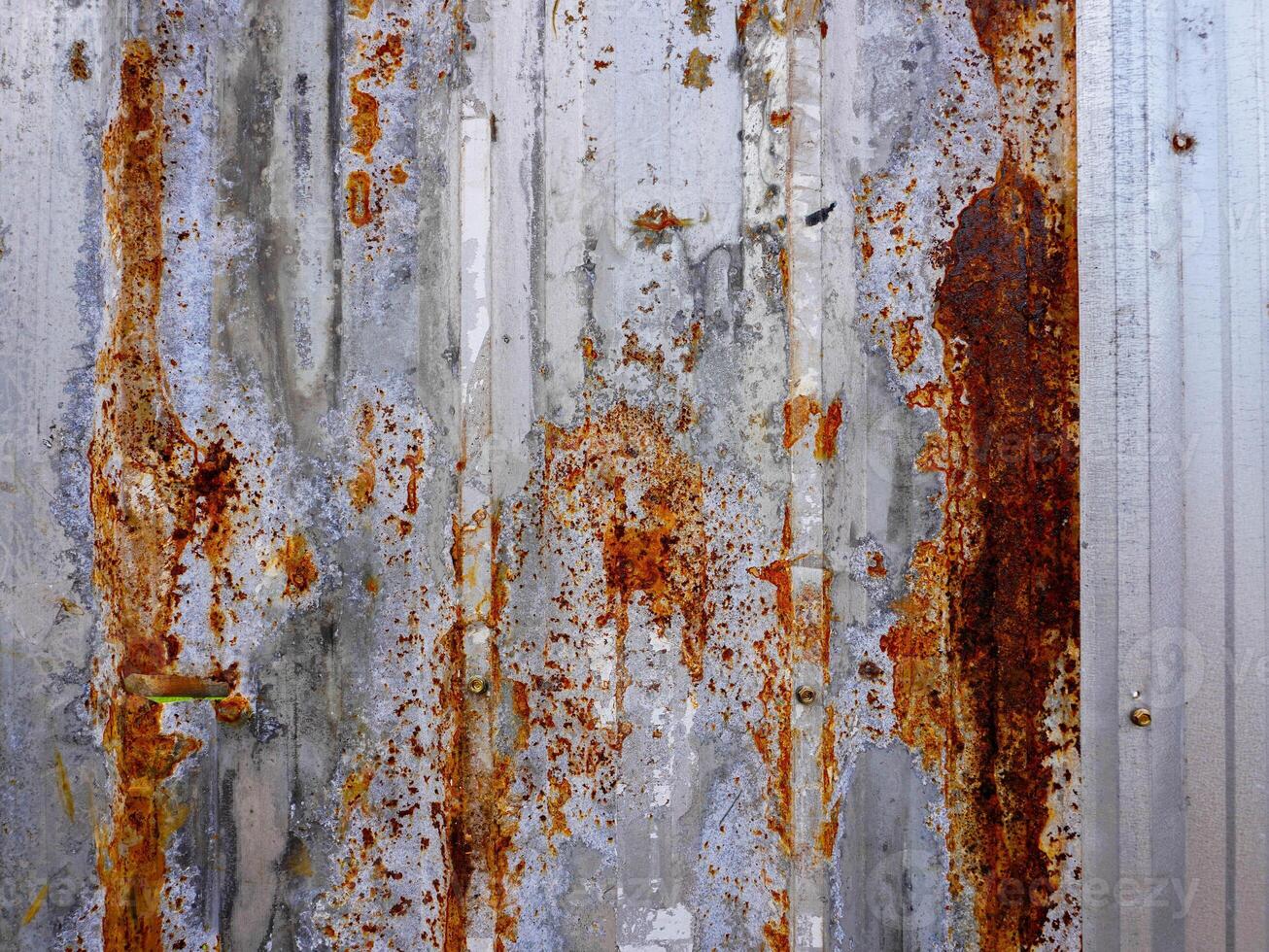 Corroded metal background. The metal walls have rust spots. Rusted metal background with rust marks, rust stains. Rystycorrosion photo