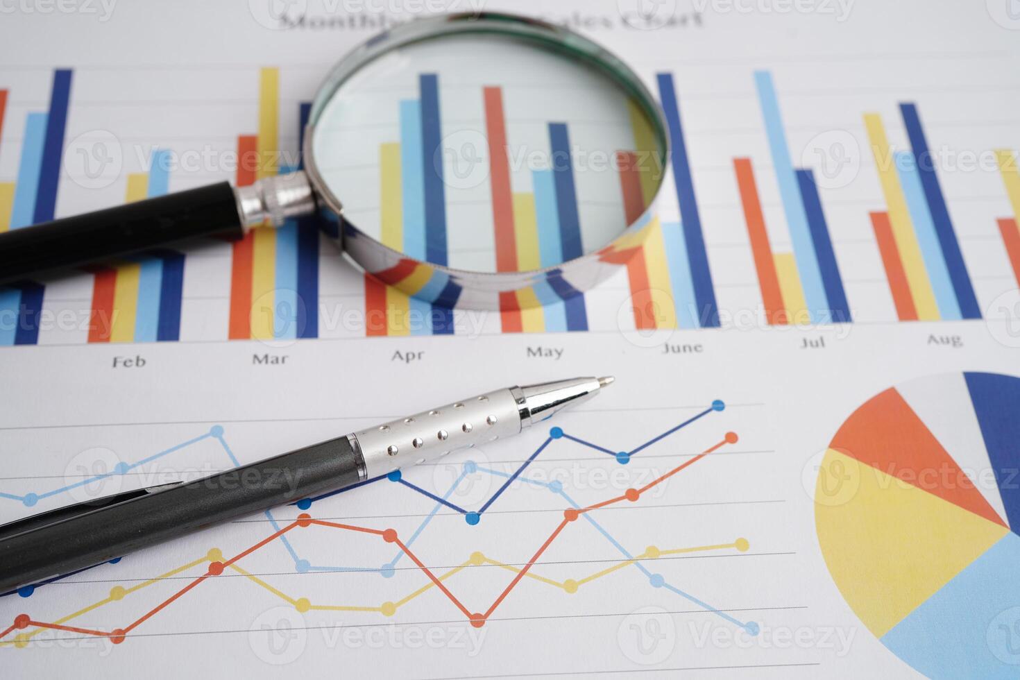 Magnifying glass on charts graphs paper. Financial development, Banking Account, Statistics, Investment Analytic research data economy. photo