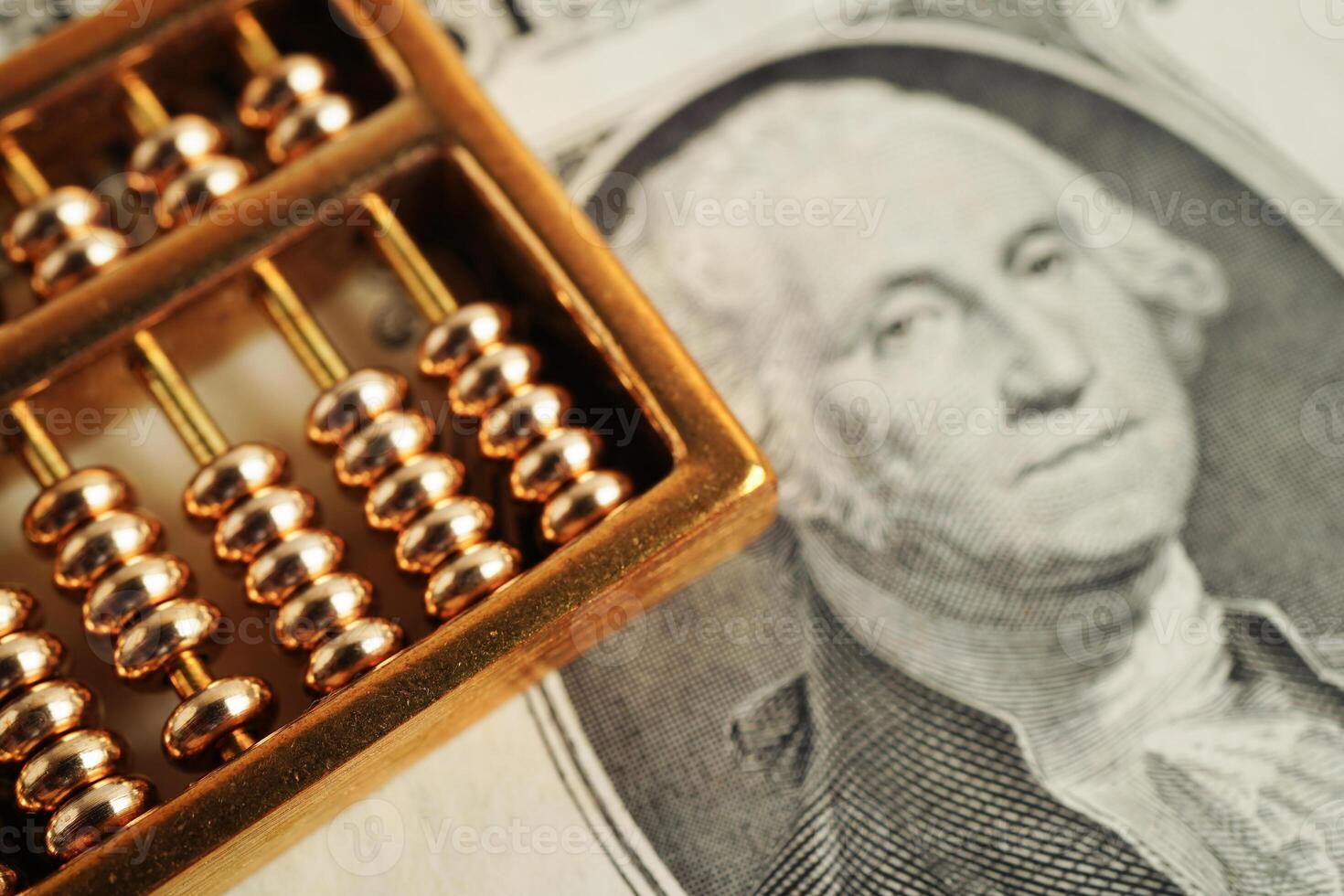 Gold abacus on banknote money, finance trading investment business currency concept. photo