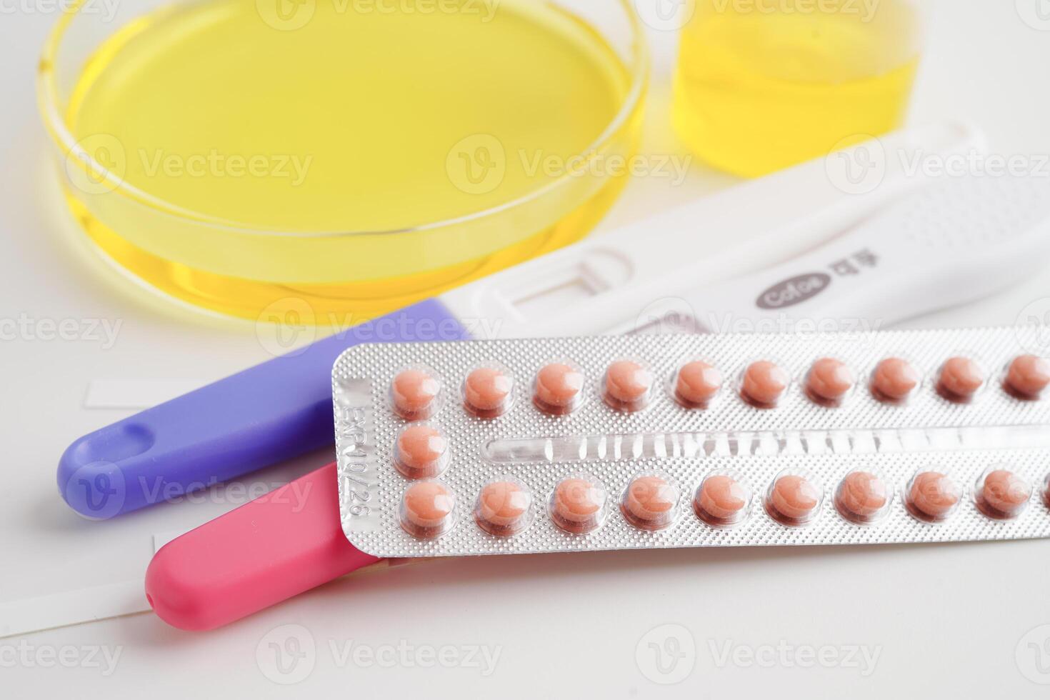 Urinalysis, pregnancy test and urine cup for female of ovulation day, fetus, maternity, childbirth, birth control. photo