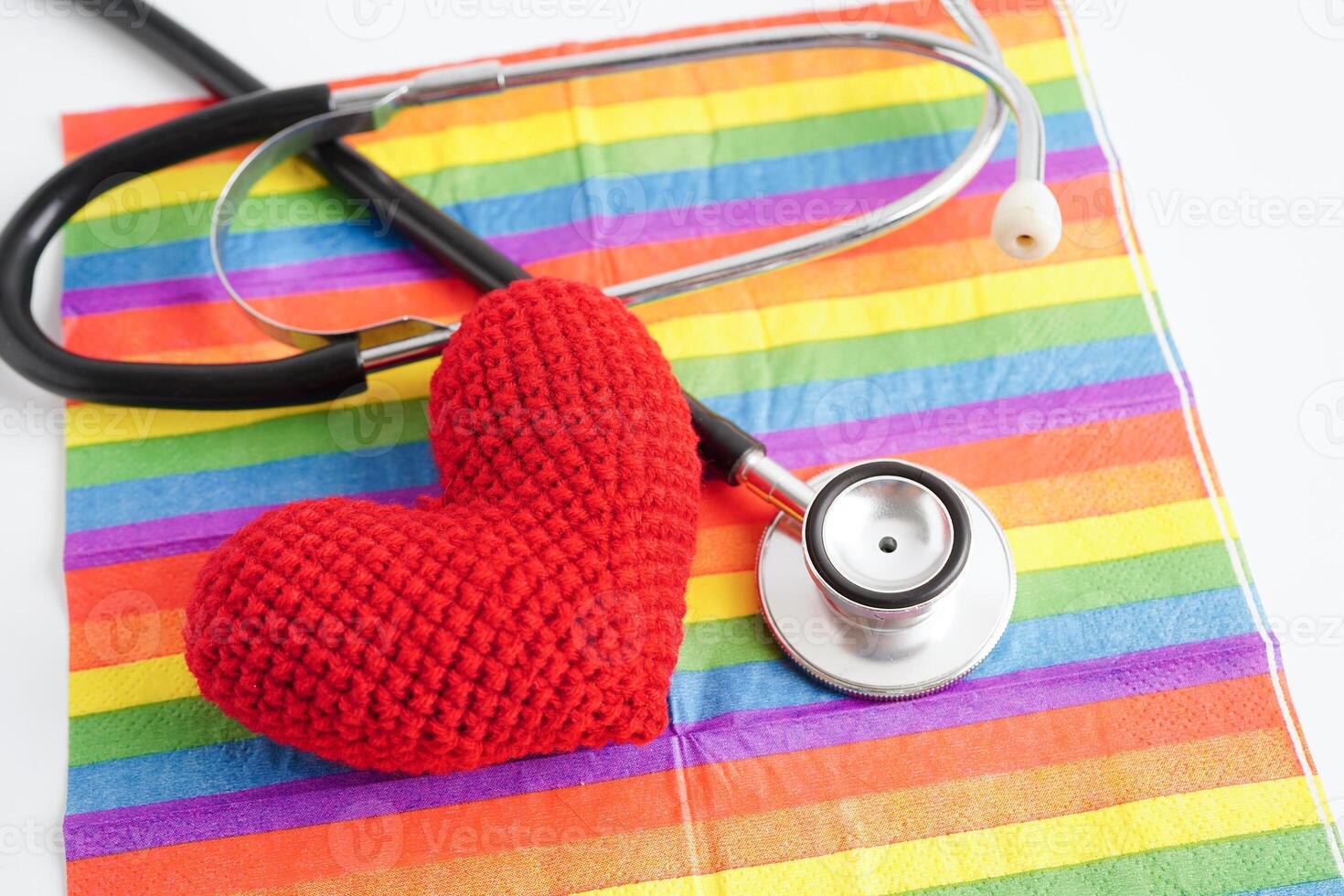 LGBT symbol, Stethoscope with red heart on rainbow flag, rights and gender equality, LGBT Pride Month in June. photo