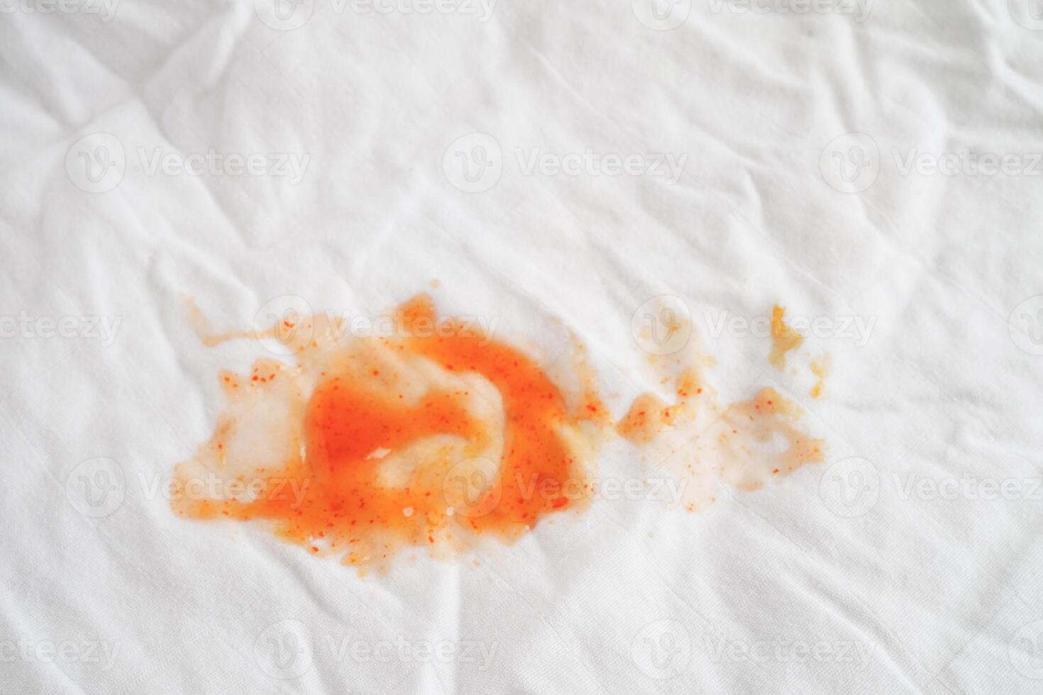 Dirty tomato sauce stain or ketchup on cloth to wash with washing powder, cleaning housework concept. photo
