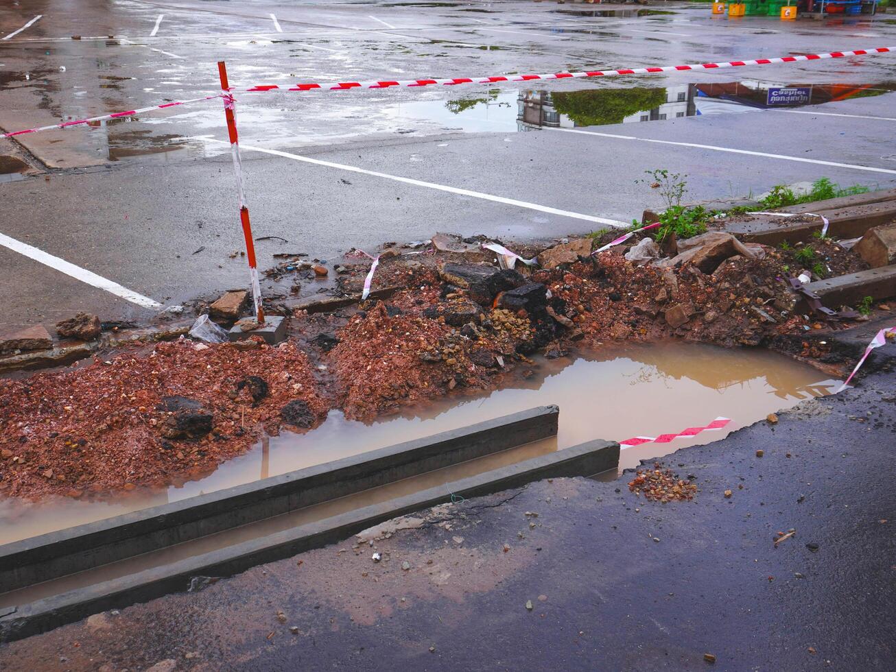 Close-up of road being excavated for renovation, repair of main city road, road construction, pothole during rainy season. photo